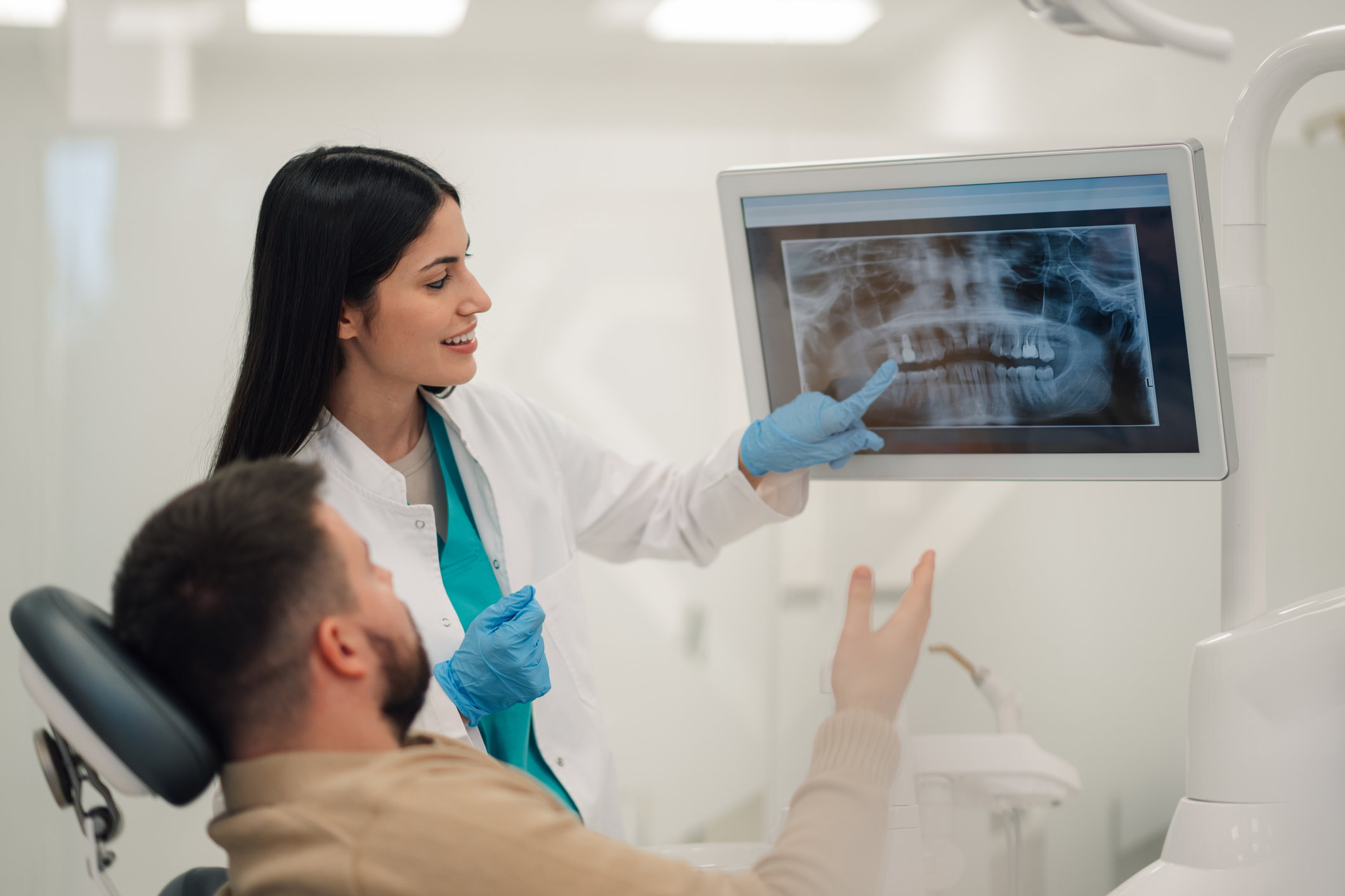 Dentist showing a patient their X-rays during a dental visit