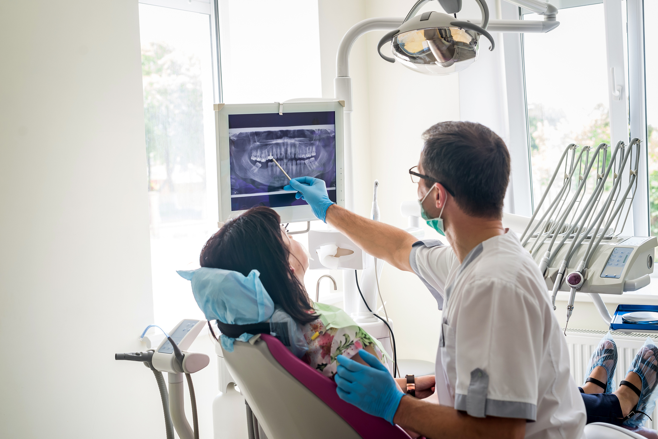 A dentist showing a patient their dental X-ray