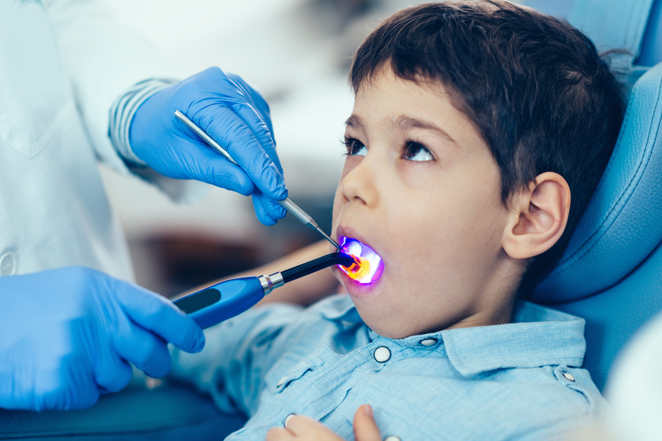 Pediatric patient receiving a dental sealant