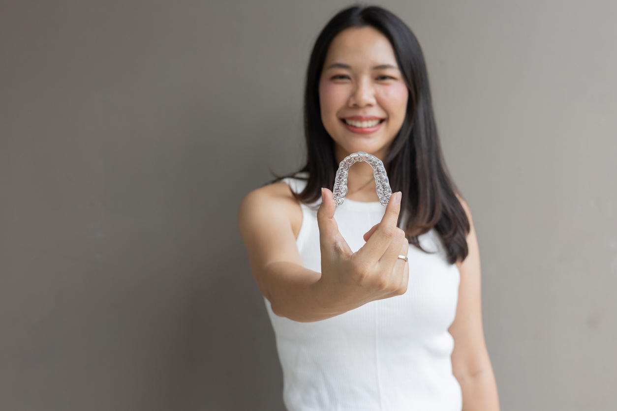 CLose up of patient holding their clear aligner