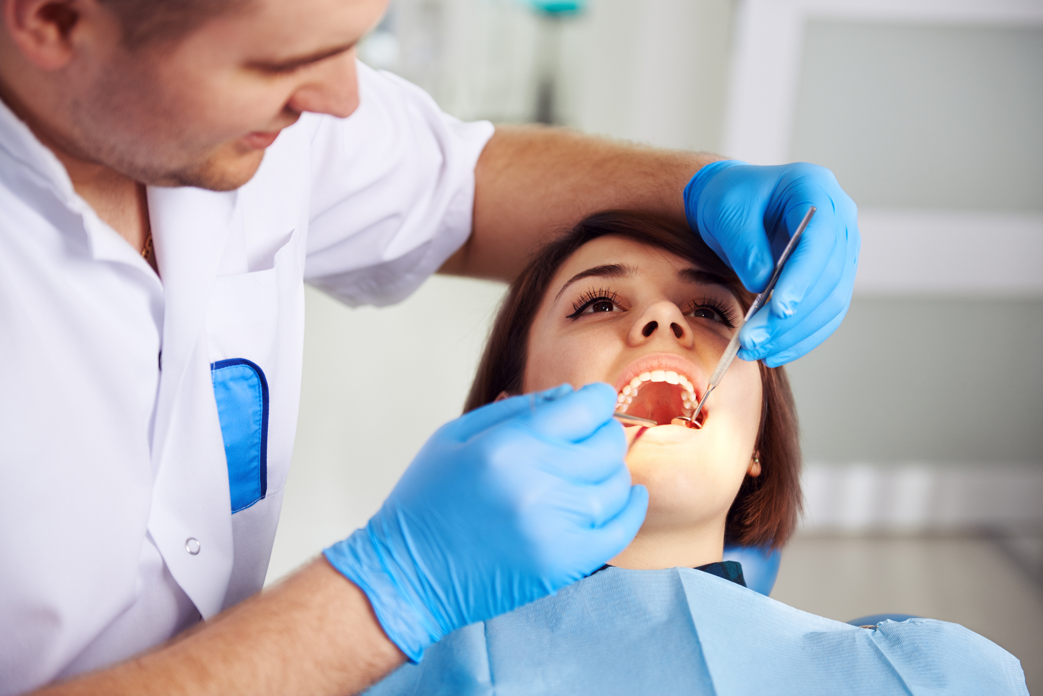 Dentist examining patient