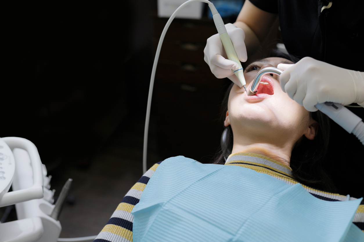 Patient receiving a teeth cleaning at the dental office